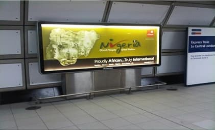 The Nigeria — Good People, Great Nation panel lit above the Heathrow Express platform at Heathrow.